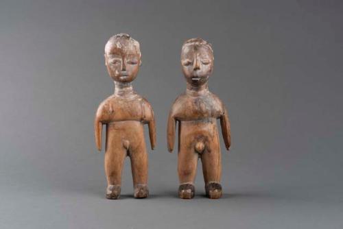 One of a pair of engraved and carved sculptures depicting twins