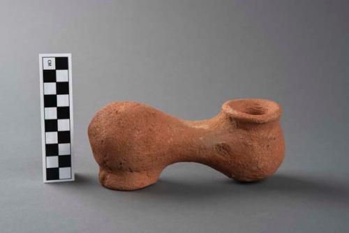 Terracotta object indicating position of twins at birth, one of a group of four.