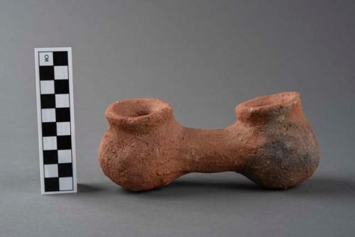 Terracotta object indicating position of twins at birth, one of a group of four.