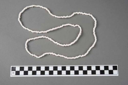 Bracelet strung with plastic corals, one of a group of seven.