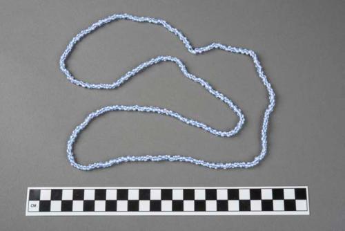 Bracelet strung with plastic corals, one of a group of seven.