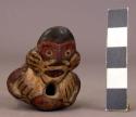 Polychrome pottery figurine whistle