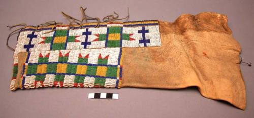 Pair of Cheyenne woman's leggings. Decorated w/ lazystitch beadwork & pigment