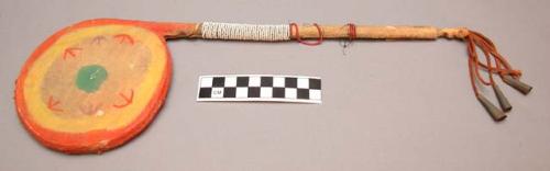 Painted rattle (gourd) with red and white beaded handle; tinkler tassel