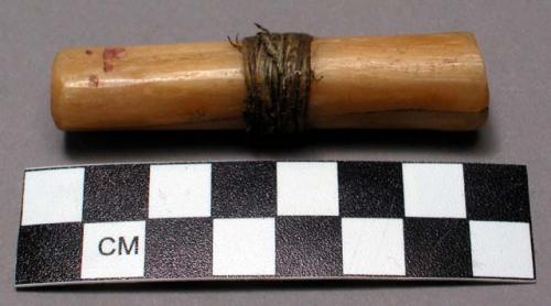 Set of bones for "lehal" or guessing game. The main bone is wrapped with sinew.