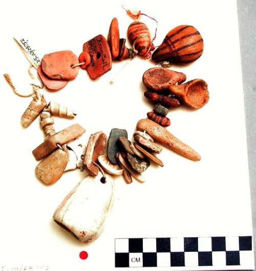 Shell, pottery and stone pendants