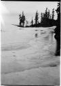 Frozen lake, with trees along shore