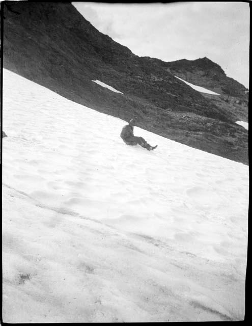 Man sitting in snow on mountain slope in the Olympic Mountains