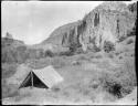 Tent, with cliff dwelling in background