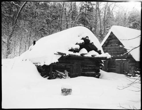 Snow covered log cabins