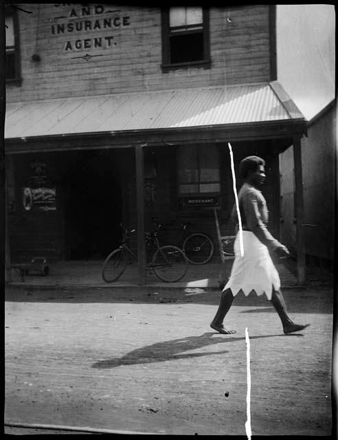 Policeman walking in front of an insurance building