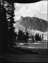 Lake and trees, with a mountain in the background