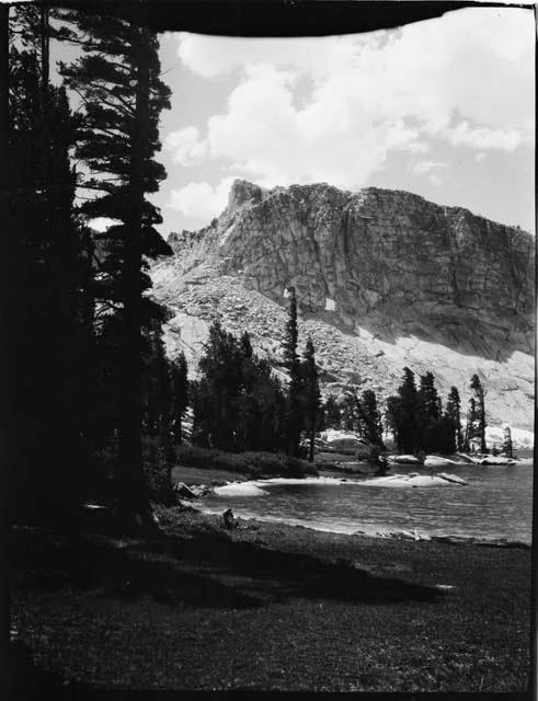 Lake and trees, with a mountain in the background