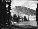 Lake and trees, with a mountain in the background