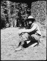 Henry Vincent Hubbard sitting against a tree trunk