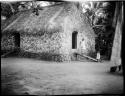 Woman and a child standing in front of a house