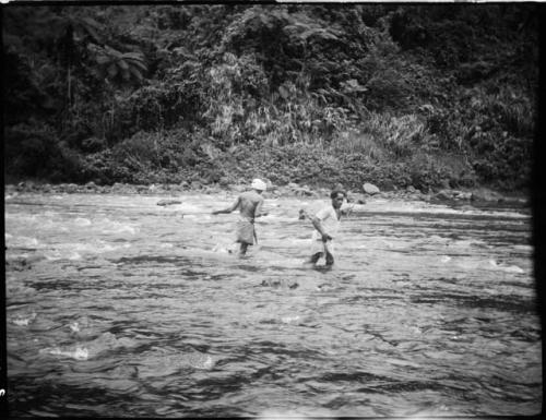 Men dragging a boat through the Navua River