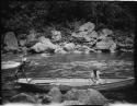 Men poling a boat along the Navua River