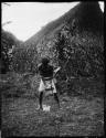 Man husking coconuts in Namuamua