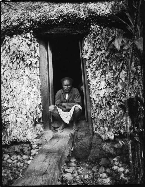 Buli at Namuamua, sitting in the doorway of a house