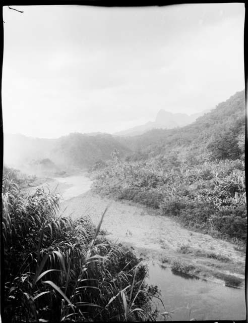 Group of people standing on a trail near Namuamua, distant view