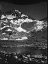 Rocky shoreline with a mountain in the background