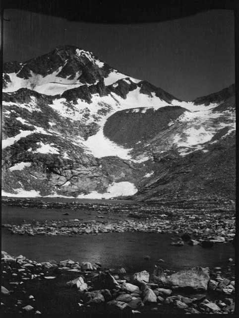 Rocky shoreline with a mountain in the background