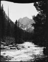 River and trees, with a mountain in the background