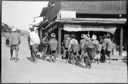 People in front of a building, with a sign reading "Chat Road"