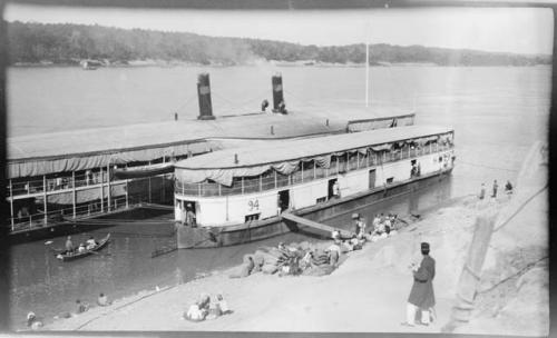 People loading an Irrawaddy Flotilla Company boat