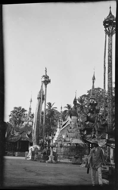 Person walking in front of pagodas