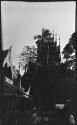 People sitting and standing in front of pagodas