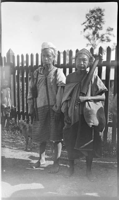 People standing in front of a fence