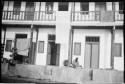 Person sitting in front of a building