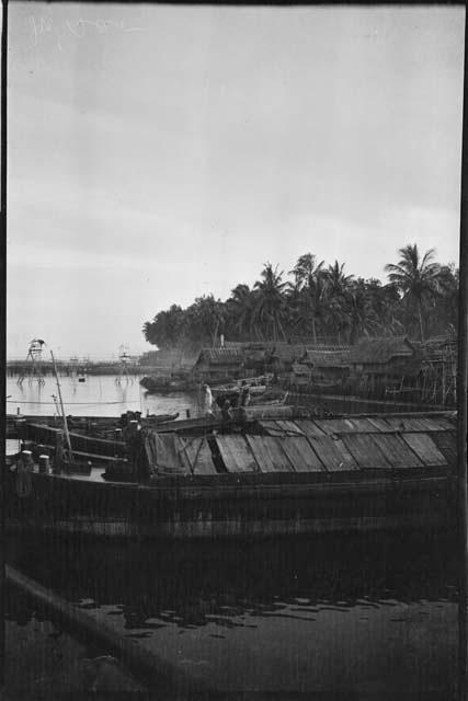 Boat, with buildings on stilts in the background