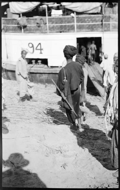 People standing next to an Irrawaddy Flotilla Company boat