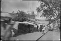 People at a market, with the dome of a building in the background