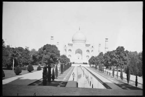 Person walking next to reflecting pool at Taj Mahal