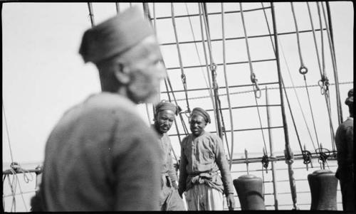 Men standing on the deck of a ship