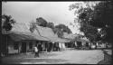 Woman walking in front of houses