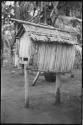 Small thatched-roof structure on stilts