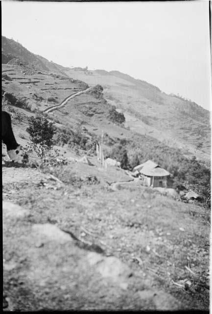 Building on a hill, with a road in the background (out of focus)