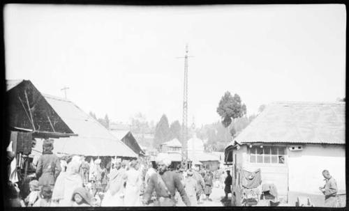 People walking and standing next to buildings