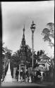 People walking in front of pagodas at Shwedagon Pagoda