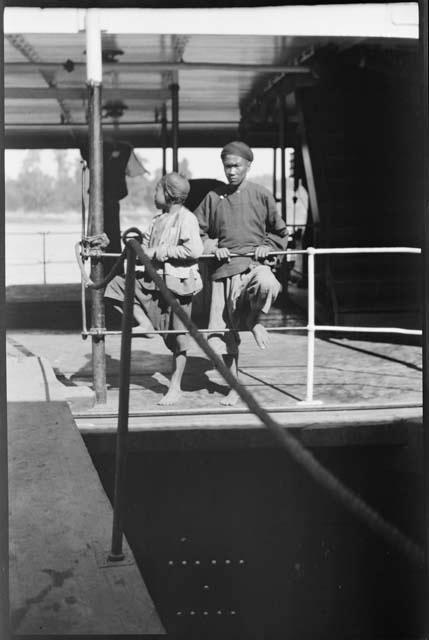 Two people on the deck of an Irrawaddy Flotilla Company boat