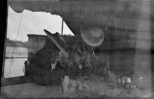 Two people sitting and eating on the deck of an Irrawaddy Flotilla Company boat