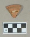 Ceramic, slip decorated redware base sherd