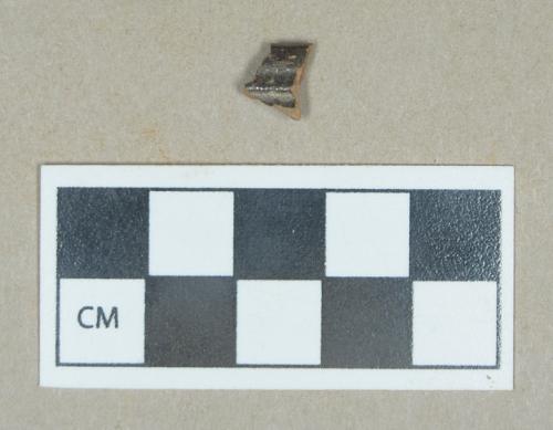 Ceramic, manganese-mottled redware rim sherd