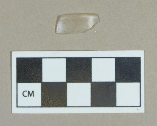 Glass, colorless curved rim fragment