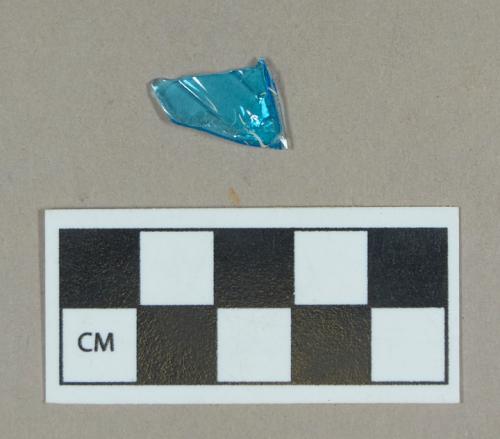 Glass, blue curved body fragment, molded